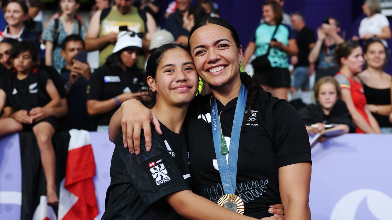 Gold medalists of Team New Zealand Stacey Waaka #3 poses with a family member after the Women's Rugby Sevens medal ceremony following the Women's Rugby Sevens matches on day four of the Olympic Games Paris 2024 at Stade de France on July 30, 2024 in Paris, France. (Photo by Cameron Spencer/Getty Images)