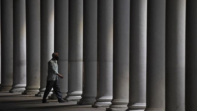 A man walks past closed stores in New Delhi. Picture: Tauseef Mustafa / AFP.