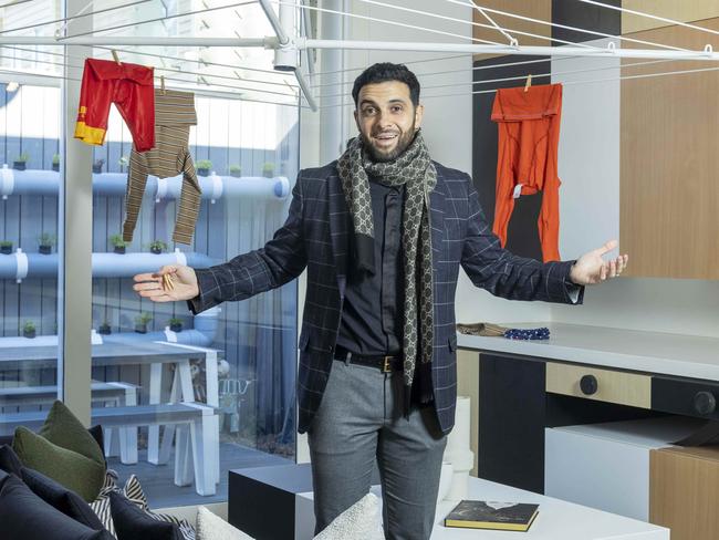 Bizarre Yarraville home for sale. Estate agent Huss Saad  inside the home with the functioning Hills Hoist chandelier.Picture by Wayne Taylor 6th July 2022