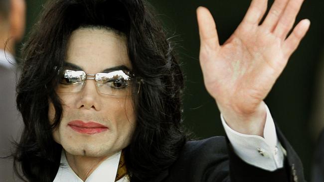 Jackson waves to supporters outside court in 2005. Picture: AFP