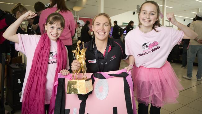 Connie Milford, 9, and her sister, Indianna Milford, 11, with Thunderbirds captain Hannah Petty at Adelaide Airport, after the team’s grand final win. Picture: Matt Loxton