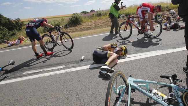 Laurens ten Dam of the Netherlands, centre, lies on the road after the crash.