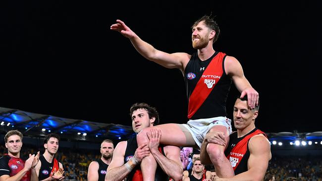 Dyson Heppell of the Bombers is chaired off the field after playing his last game against Brisbane in the final round. Picture: Albert Perez