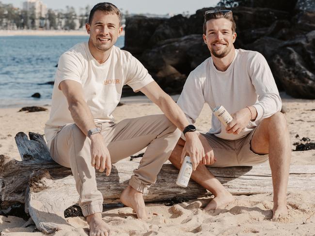 Northern beaches' entrepreneurs Oliver Budniak and Emlyn Gavin on Shelly Beach with their new "Hard Kombucha". Picture: DANIELLE NIEUWENDYK