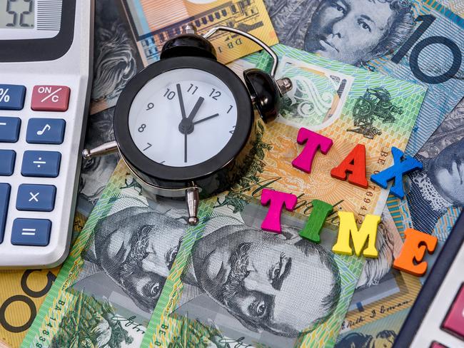 Australian dollars with clock and 'tax time' text; taxation generic calculator money