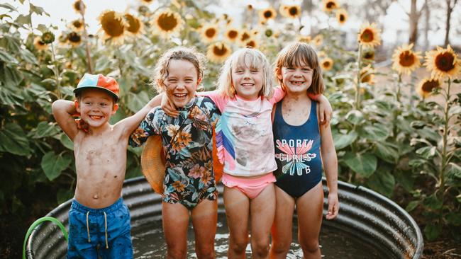 Siblings Trader, 4, Dolly 7, and Daisy, 5, and their friend Abigail, 7, second left, try to stay cool in their Narromine home’s backyard, where Saturday’s temperature is tipped to hit 46C. Picture: Clancy Paine