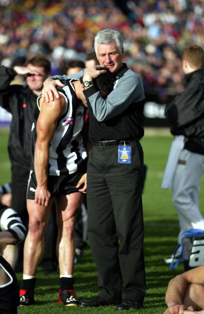 2002: Coach Mick Malthouse consoles a distraught Paul Licuria after 91,817 fans saw Collingwood go down to the Brisbane Lions by nine points in the Grand Final. Picture: Michael Dodge