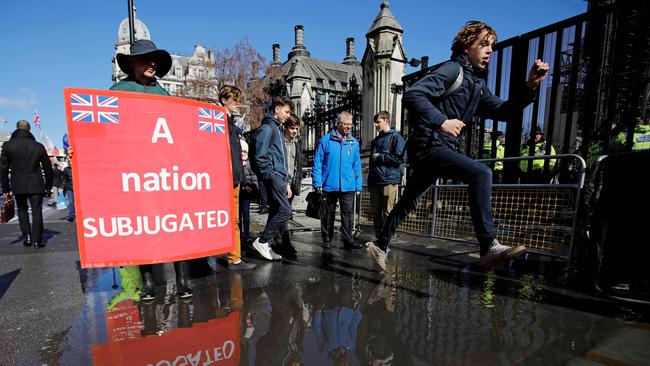 A pro-Brexit activist demonstrates outside of the Houses of Parliament in London as inside, the parties are split on the issue. Picture:  AFP