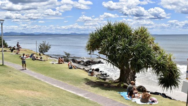 Tourists had to sunbathe from the park as Byron Bay's Main Beach disappeared due to rough seas on Monday.