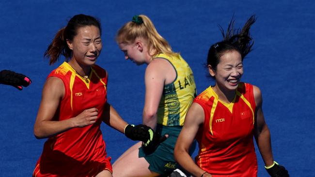 PARIS, FRANCE - AUGUST 05: Team People's Republic of China celebrate a victory following the Quarter Final Women's match between Australia and People's Republic of China on day ten of the Olympic Games Paris 2024 at Stade Yves Du Manoir on August 05, 2024 in Paris, France. (Photo by Clive Brunskill/Getty Images)