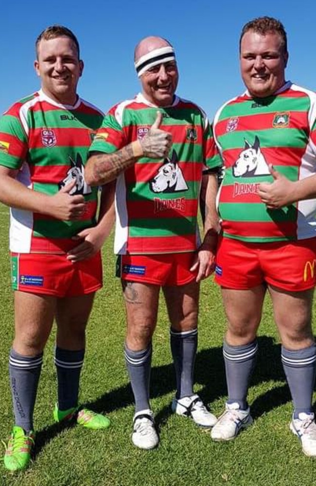 Jayden Klein with his dad Russell and his brother Jai in their football gear.