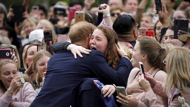 And, against royal protocol, he embraces the teenager. Picture: Phil Noble/Pool Photo/AP