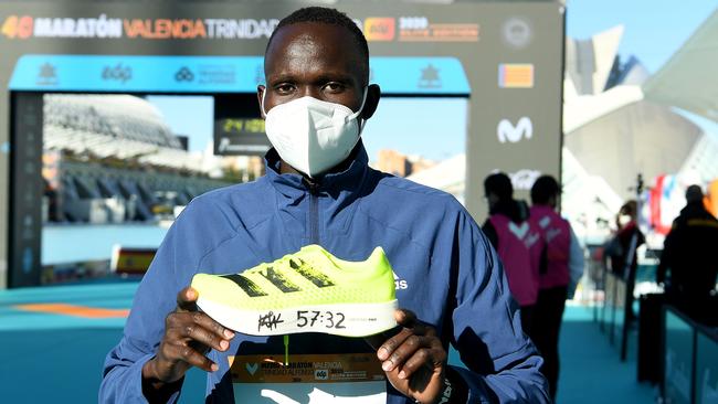 Kibiwott Kandie of Kenya poses with the Adidas Adizero Adios Pro after breaking the men’s half-marathon world record at the Valencia Marathon in Spain on Sunday night (AEDT). Picture: Getty Images