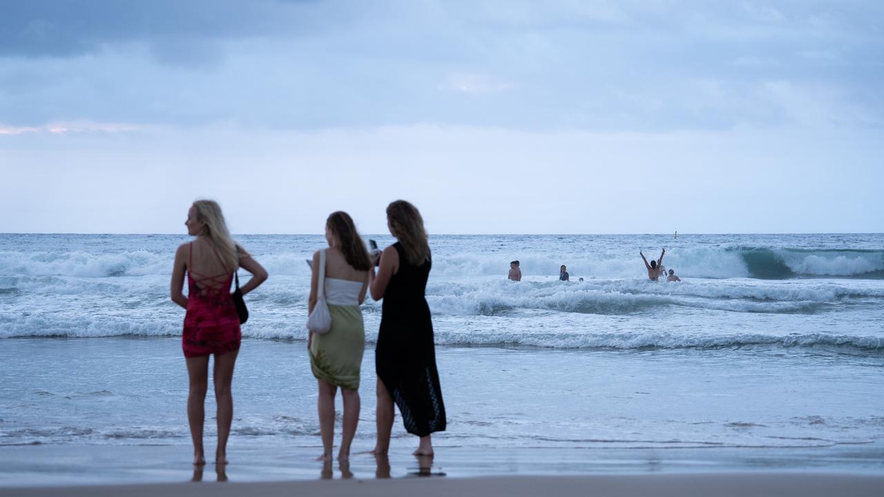 Many took to the beach in the clothes they partied into 2024. Picture: NCA NewsWire / Mario Francisco