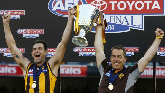 Luke Hodge raises the 2014 premiership cup with coach Alistair Clarkson. Picture: Michael Klein