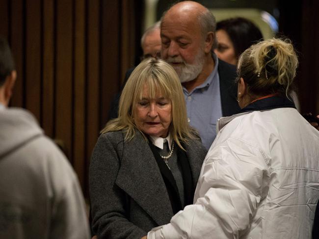 Reeva Steenkamp's mother June (C) and her father Barry arrive at the High Court in Pretoria.