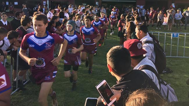 Wavell SHS players charge onto the new field at Marsden SHS.