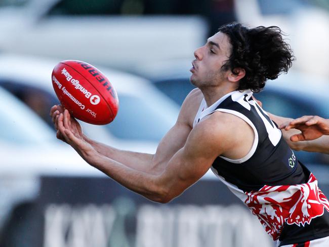 Devon Meadow's Patrick Boland marks at full stretch. Picture: David Trend