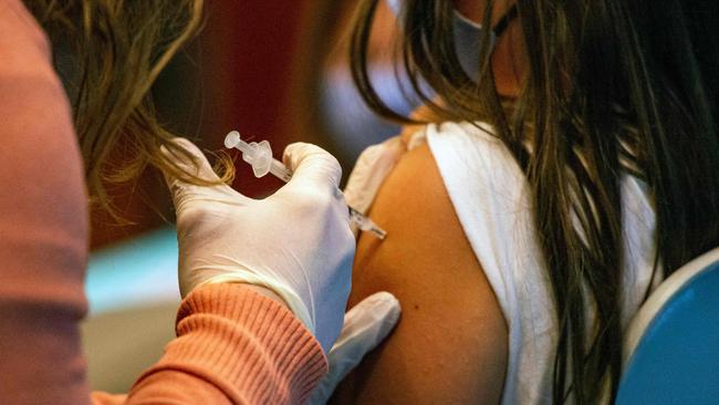 A five year old child receives the Pfizer-BioNTech Covid-19 Vaccine for 5-11 year old kids at Hartford Hospital in Hartford, Connecticut on November 2, 2021. - An expert panel unanimously recommended Pfizer-BioNTech's Covid vaccine for five- to 11-year-olds on November 2, the penultimate step in the process that will allow injections in young children to begin this week in the United States. The Centers for Disease Control and Prevention (CDC), the top US public health agency, was expected to endorse that recommendation later in the day. (Photo by JOSEPH PREZIOSO / AFP)