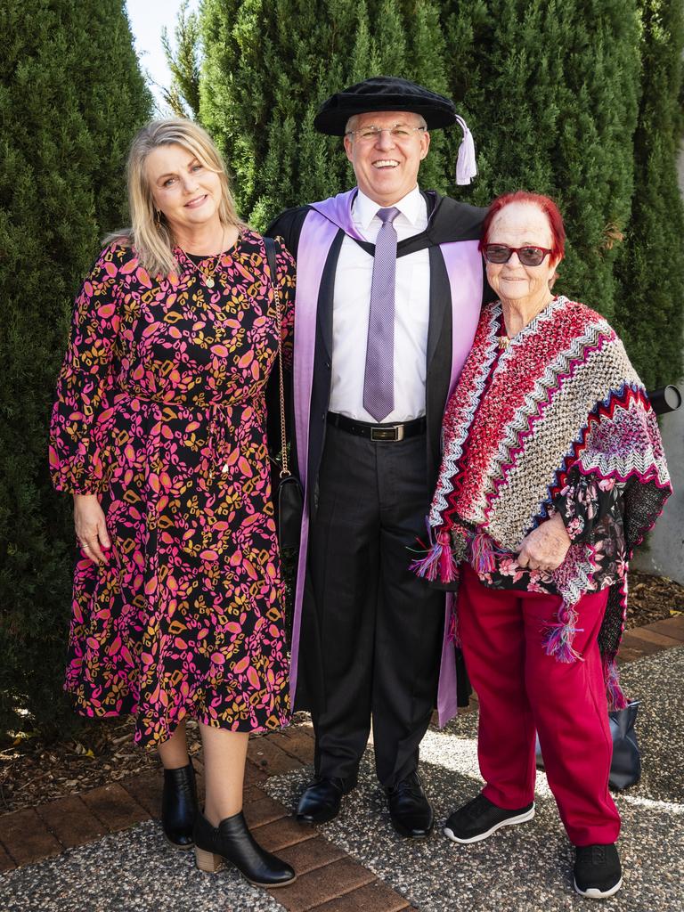 Doctor of Professional Studies graduate Troy Dux is congratulated by his wife Sharon Dux and mum Wendy Dux at the UniSQ graduation ceremony at Empire Theatres, Tuesday, June 27, 2023. Picture: Kevin Farmer