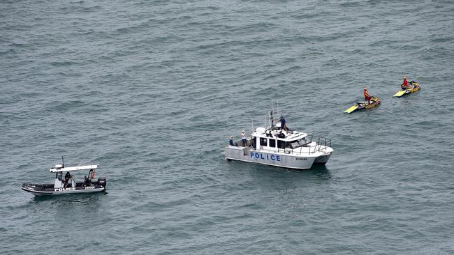 Police and rescue services are at the scene of a Tiger Moth plane crash in the ocean off South Stradbroke Island near the Gold Coast. Pics Adam Head