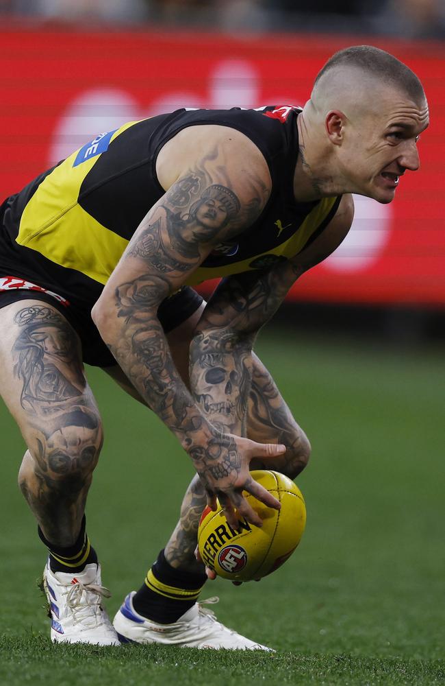 Richmond’s Dustin Martin grimaces as he picks up the ground ball moments before being subbed out during the third quarter. Picture: Michael Klein