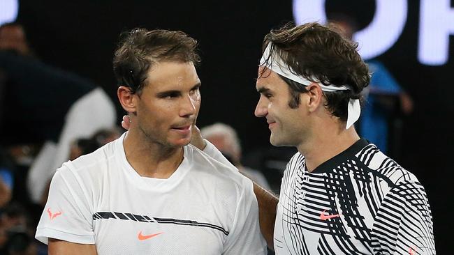 (L-R) Rafael Nadal and Rodger Federer meet at the net after the epic Australian Open match. Picture: Julie Kiriacoudis