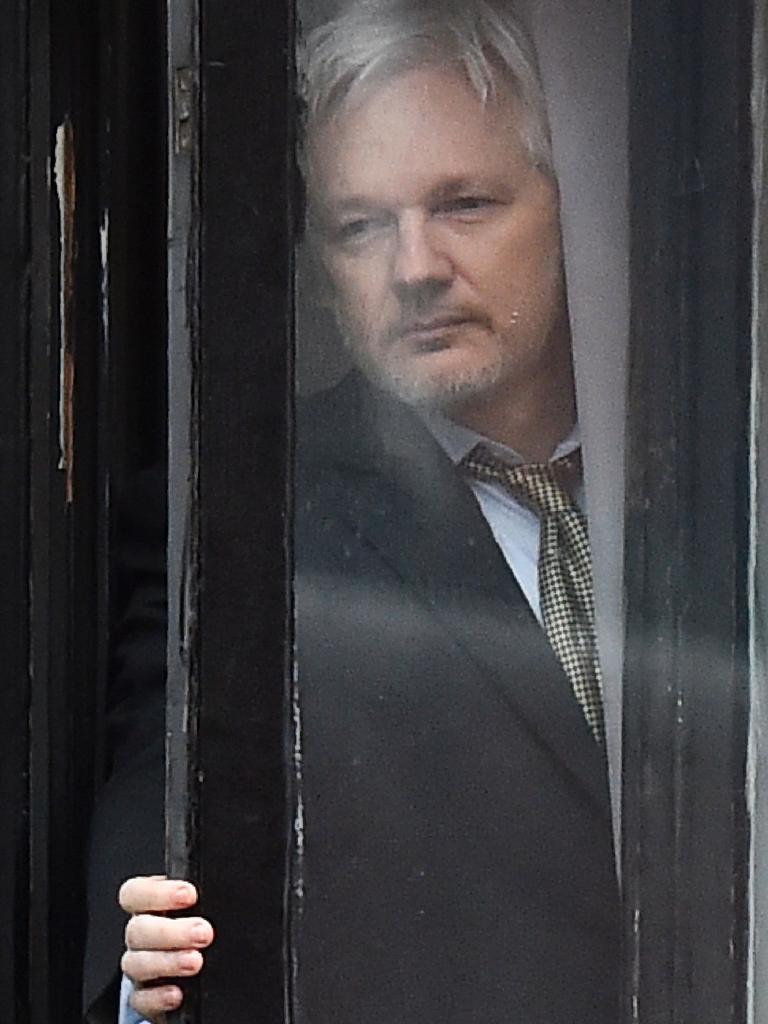 WikiLeaks founder Julian Assange coming out on the balcony of the Ecuadorean embassy. Picture: AFP