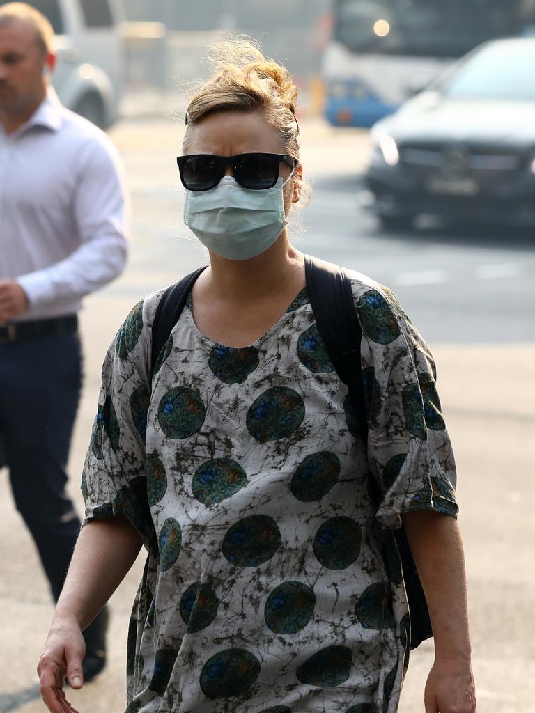 As smoke from bushfires engulfs Sydney, morning commuters are pictured wearing face masks as they make their way to work. Picture: MATRIX