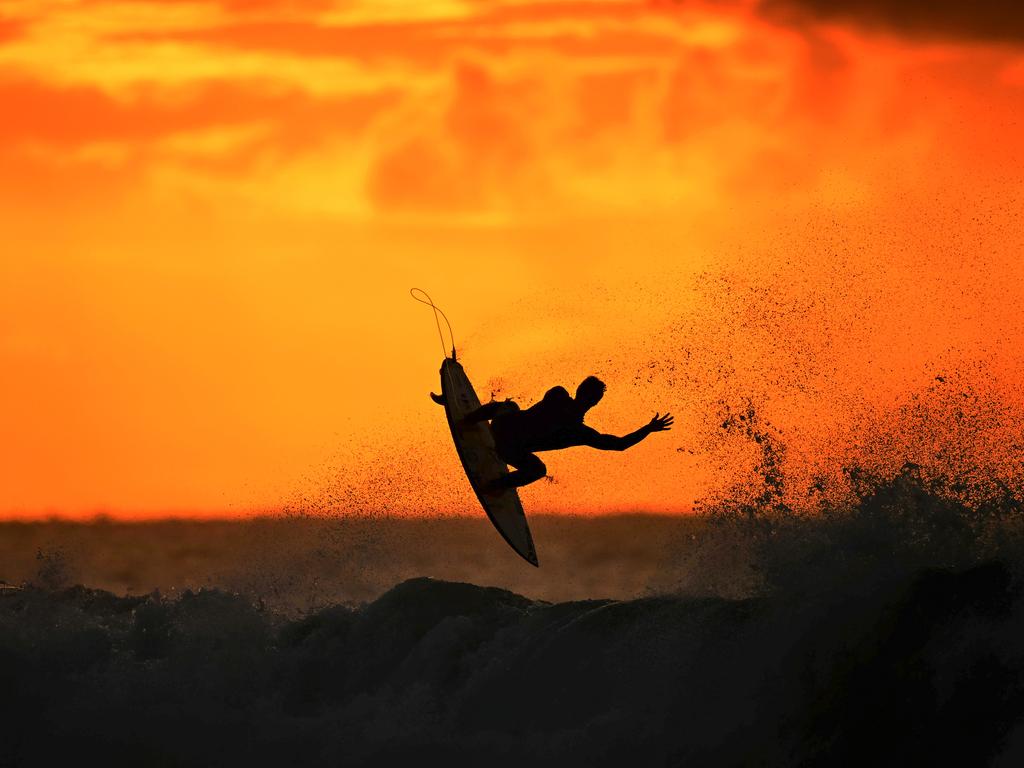 A surfer warmed up at sunrise ahead of the 2024 Rip Curl Pro Bells Beach, catching the first light of the day at Winkipop. Picture: Getty