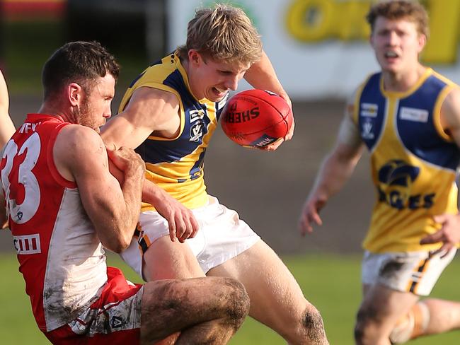 North Warrnambool’s Harry Keast is tackled in muddy conditions last weekend. The team is chasing its first premiership in the Hampden Football Netball League. Picture Yuri Kouzmin