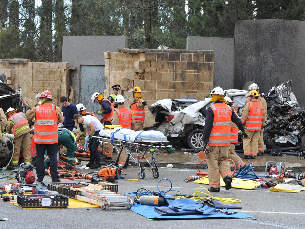 Emergency service workers at the crash on the corner of Glen Osmond and Cross roads. Picture: Roger Wyman