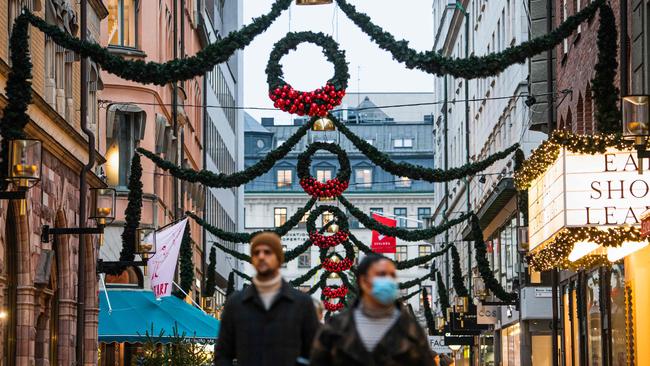 People walk past shops under Christmas decorations in Stockholm on December 3. Picture: Jonathan Nackstrand/AFP