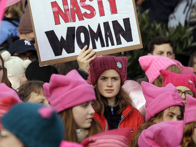 A woman holds a sign amidst a sea of pink caps before a women's march Saturday, Jan. 21, 2017, in Seattle. Women across the Pacific Northwest marched in solidarity with the Women's March on Washington and to send a message in support of women's rights and other causes. (AP Photo/Elaine Thompson)