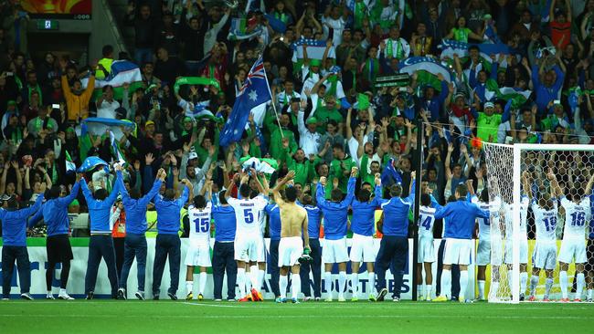 Uzbekistan players and officials celebrate with their fans in Melbourne.