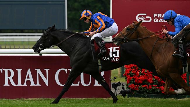Camille Pissaro, ridden by Ryan Moore, wins the French Derby at Chantilly overnight. Picture: Hugo Mathy / AFP