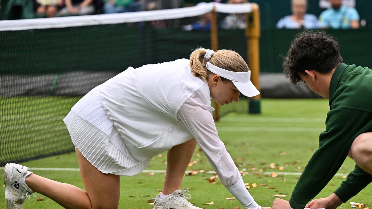 Saville showed great sportsmanship and helped clean up the orange confetti thrown on her court. Picture: Glyn KIRK / AFP