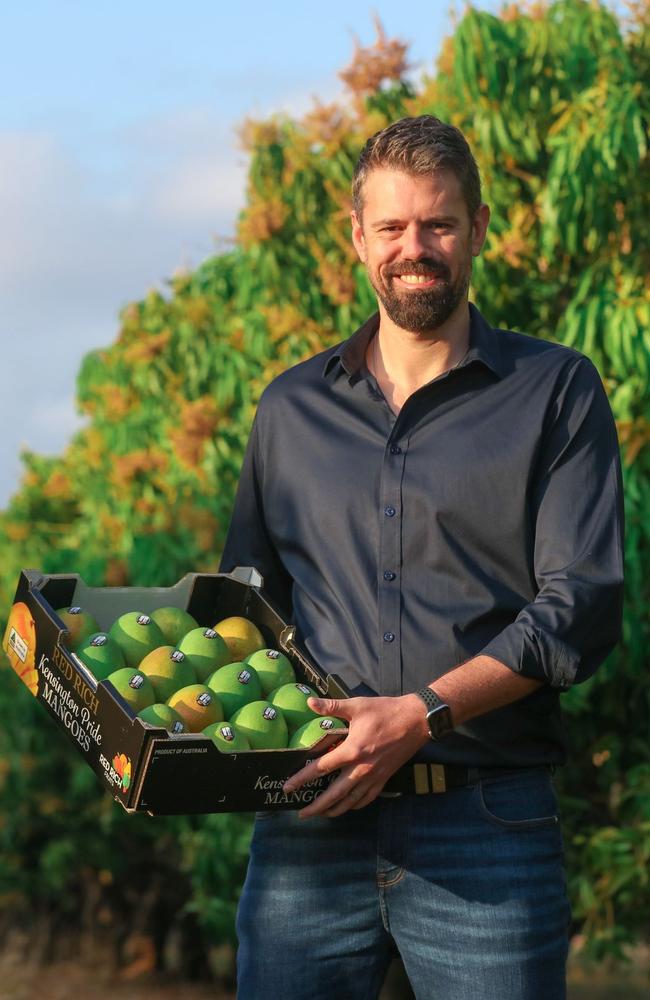 Matthew Palise from Red Rich Fruits with a box of mangoes