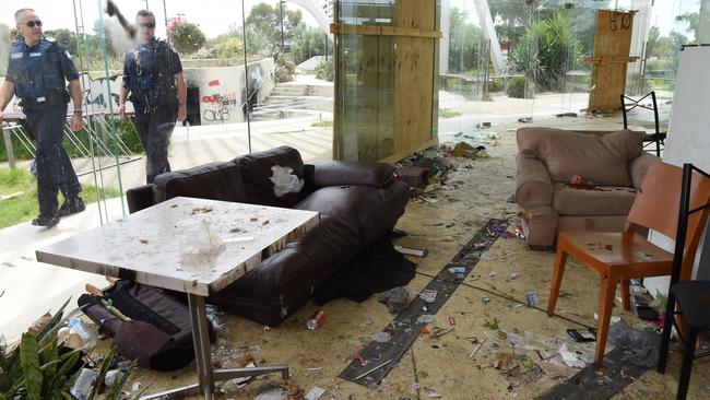 Police inspect the trashed community centre. Picture: Nicole Garmston