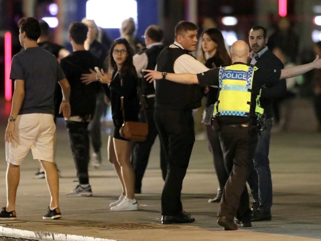 A police officer clears people away from the area near London Bridge. Picture: AP Photo/Matt Dunham