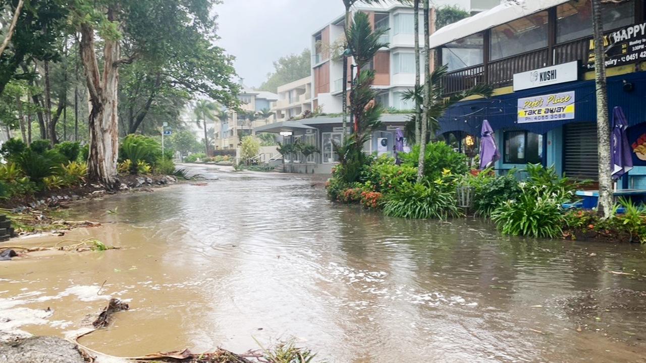 A large high tide and strong winds combined with the arrival of Tropical Cyclone Jasper in Far North Queensland to flood Williams Esplanade at Palm Cove. Picture: Brendan Radke