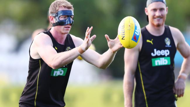 Dylan Grimes trains in a face mask to protect his broken nose.