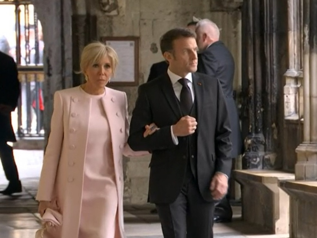 The President of France, Emmanuel Macron, and Brigitte Macron enter Westminster Abbey for the Kings Coronation. Supplied