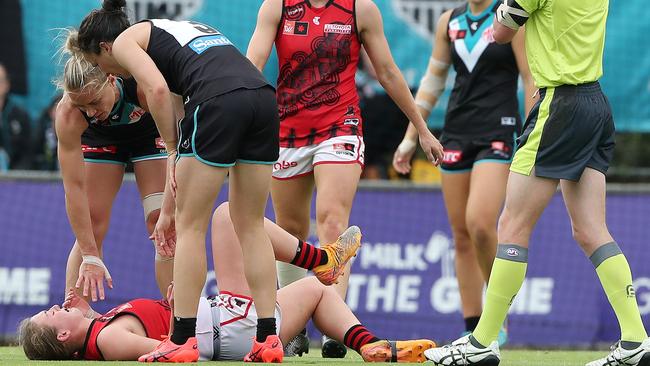 Nice touch: Port players Erin Phillips and Ange Foley show their concern after Lily-Rose Williamson’s awkward tumble. Picture: Sarah Reed/AFL Photos via Getty Images