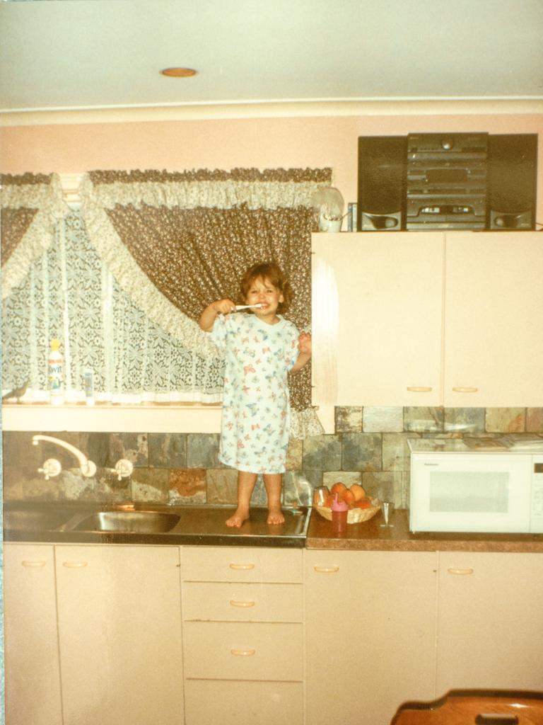 <b>BLAST FROM THE PAST:</b> Gemma Dalzotto cleaning her teeth on the kitchen sink of her Para Vista home that is now back in the family after eight years. Picture: supplied