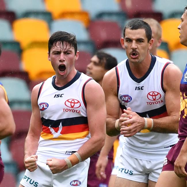 Chayce Jones (centre) of the Crows celebrates kicking a goal against Brisbane on Sunday. Picture: AAP/DARREN ENGLAND