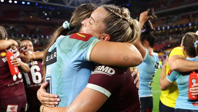 BRISBANE, AUSTRALIA - MAY 16: Taliah Fiumaono of the Blues and Lauren Brown of the Maroons embrace following game one of the 2024 Women's State of Origin series between Queensland and New South Wales at Suncorp Stadium on May 16, 2024 in Brisbane, Australia. (Photo by Hannah Peters/Getty Images)