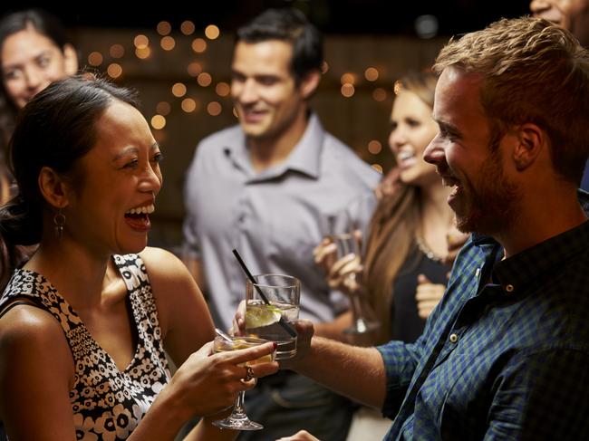 Couples Dancing And Drinking At Evening Party