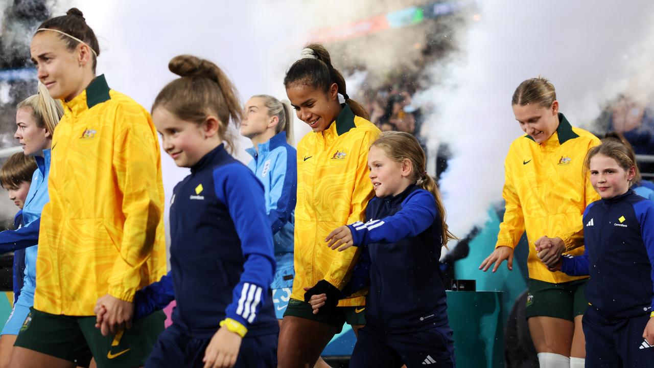 SYDNEY, AUSTRALIA - AUGUST 16: Mary Fowler of Australia walks out of the tunnel with a mascot prior to the FIFA Women's World Cup Australia &amp; New Zealand 2023 Semi Final match between Australia and England at Stadium Australia on August 16, 2023 in Sydney, Australia. (Photo by Cameron Spencer/Getty Images)