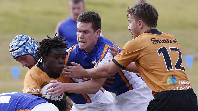 Country's Harrison Valevatu is tackled during the match against AICES.